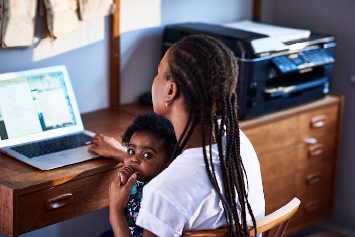mom with son on her lap, working on laptop