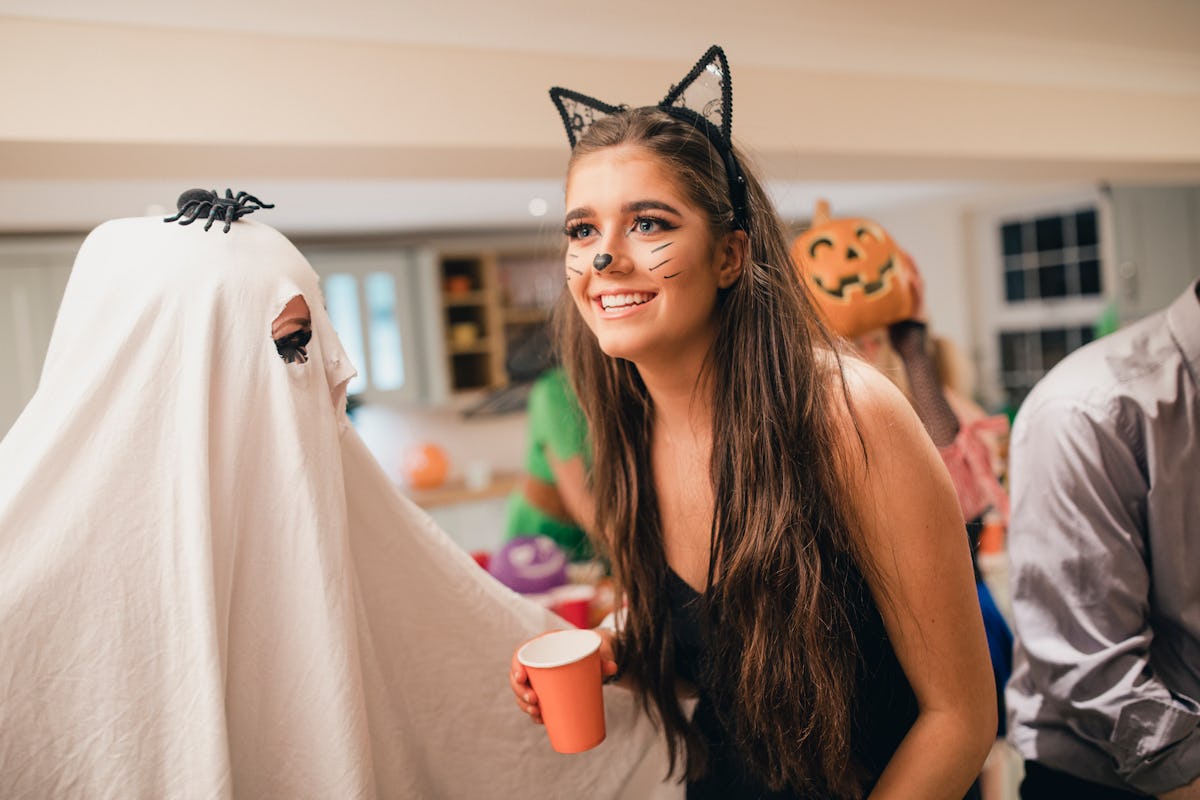 Young woman in cat Halloween costume