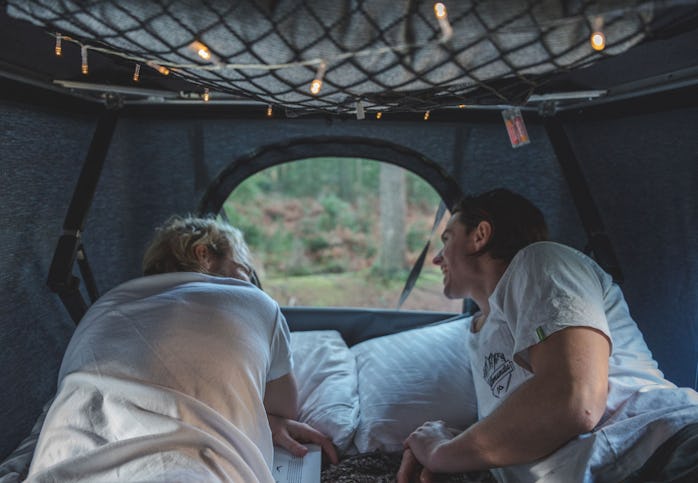 Two people in the TentBox Classic looking through a window.