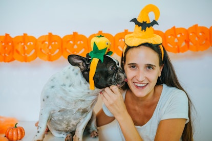 Woman with dog in Halloween costumes