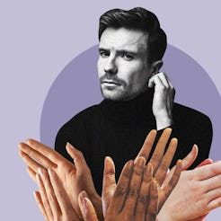 Joe Dempsie posing in a black turtleneck while a group of hands clap in front of him