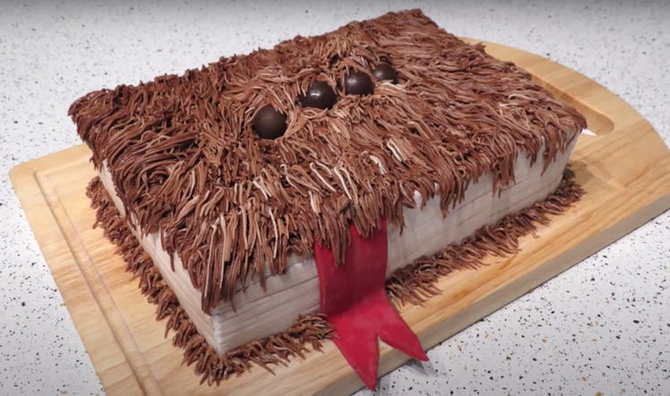 A monster book cake based off the one from 'Harry Potter' sits on a kitchen counter.