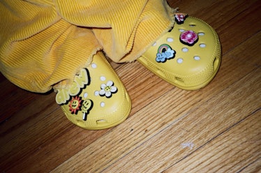 A person wearing a pair of yellow Crocs from the Justin Bieber x Crocs Collaboration