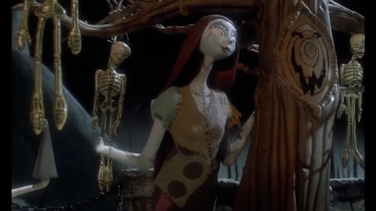 Sally from "Nightmare Before Christmas" surrounded by dangling skeletons.