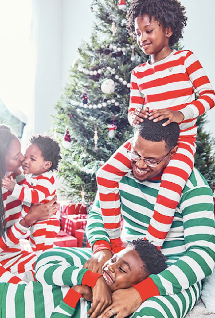 a family wearing striped holiday pajamas