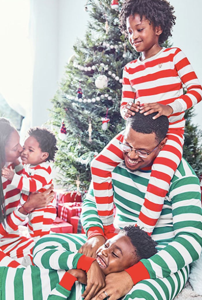 a family wearing striped holiday pajamas