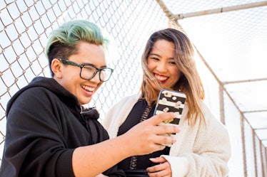 Smiling Asian women posing for selfie