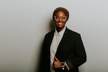 Mauree Turner posing for a photo in a black blazer