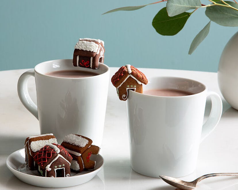 Tiny mug cookies balanced on coffee or cocoa.