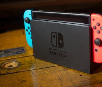 n this photo illustration, a Nintendo Switch on its Dock with 2 Joy-Con attached on it. The Kyoto ba...