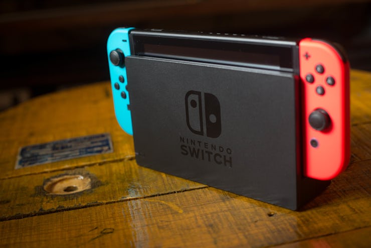 n this photo illustration, a Nintendo Switch on its Dock with 2 Joy-Con attached on it. The Kyoto ba...
