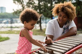 A mother and daughter playing outside.