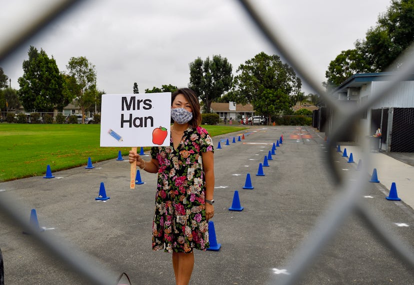  Kindergarten teacher Suzi Han greets students at Weaver Elementary School on the first day of in-pe...