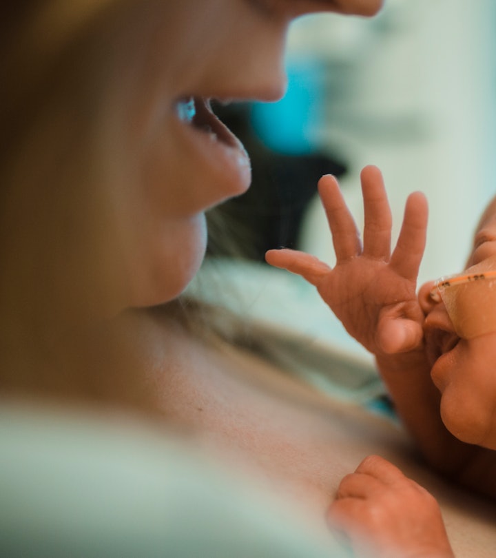 woman holding newborn preemie baby at the hospital