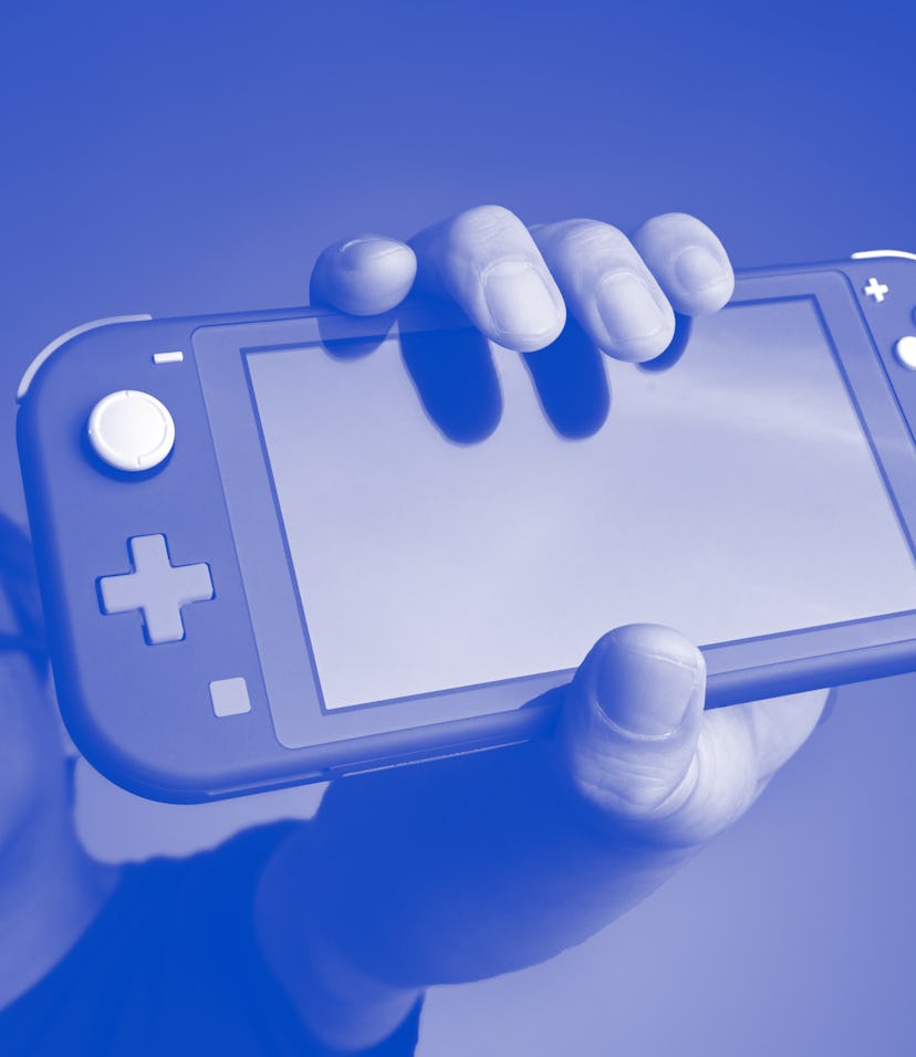 Man holding a Nintendo Switch handheld gaming console.