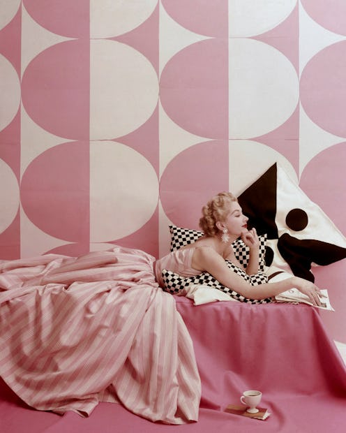 Lisa Fonssagrives wearing a vintage pink dress in front of a pink and white wall