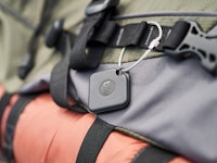 A luggage tracker attached to a khaki green bag