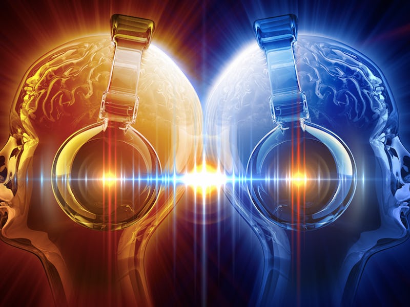 Two heads, back to back, listening to music.