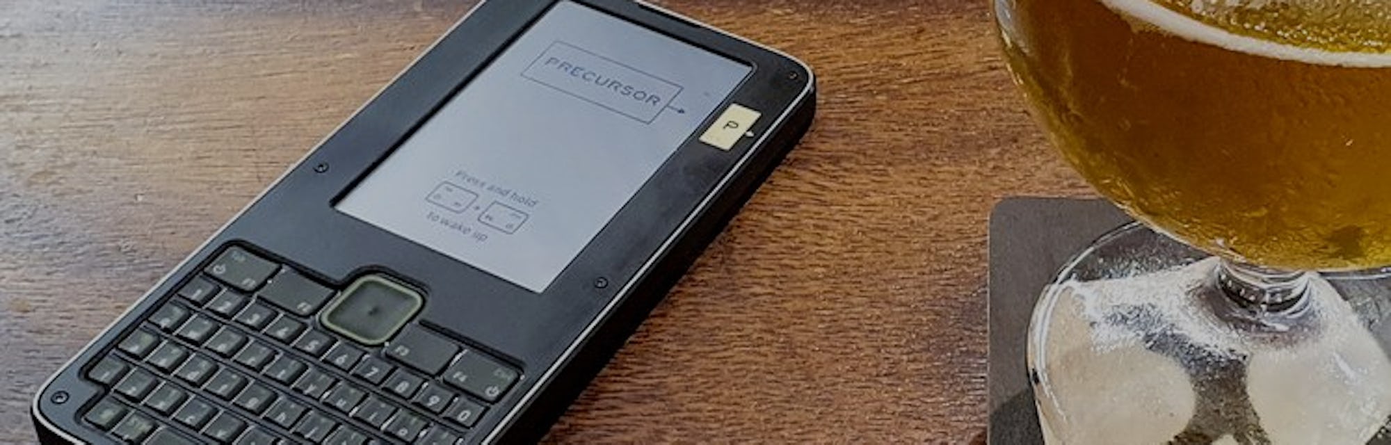 Precursor device on table next to a beer