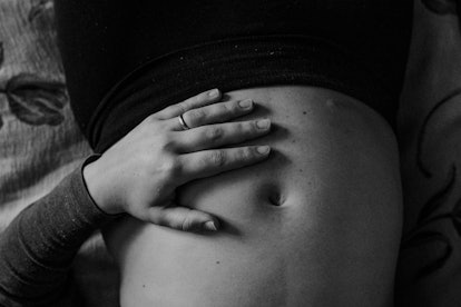 Close-up of a woman touching her stomach