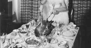 Fox actress Lillian Harvey carves the turkey for a Thanksgiving dinner, Hollywood, California, early...
