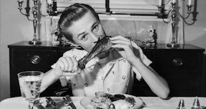 A teenager eats turkey in 1945.