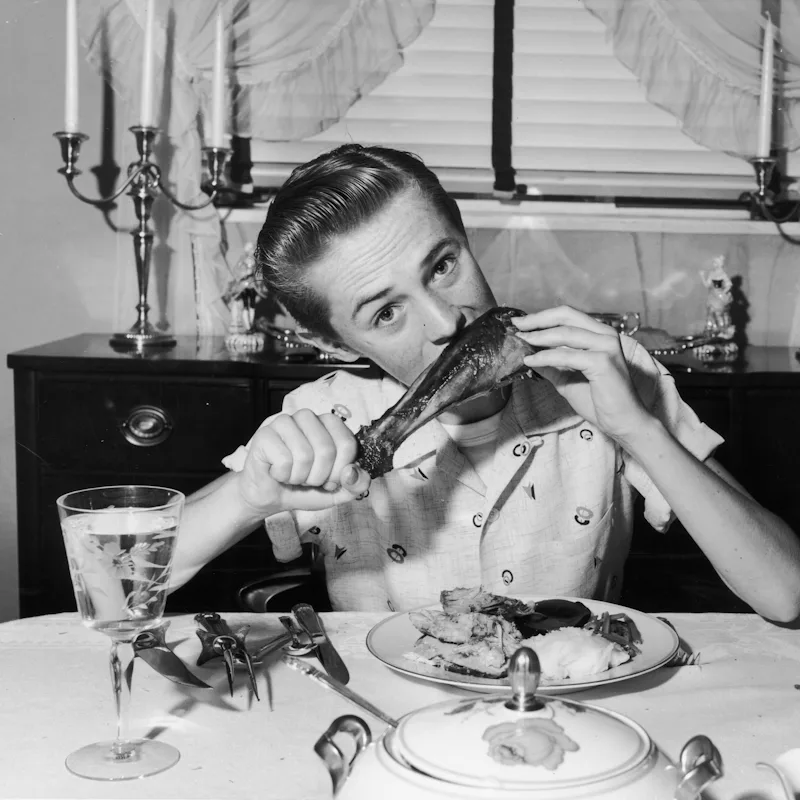 A teenager eats turkey in 1945.