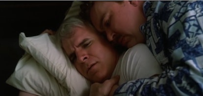 John Candy and Steve Martin lying hugged in a bed in "Planes, Trains, And Automobiles" movie