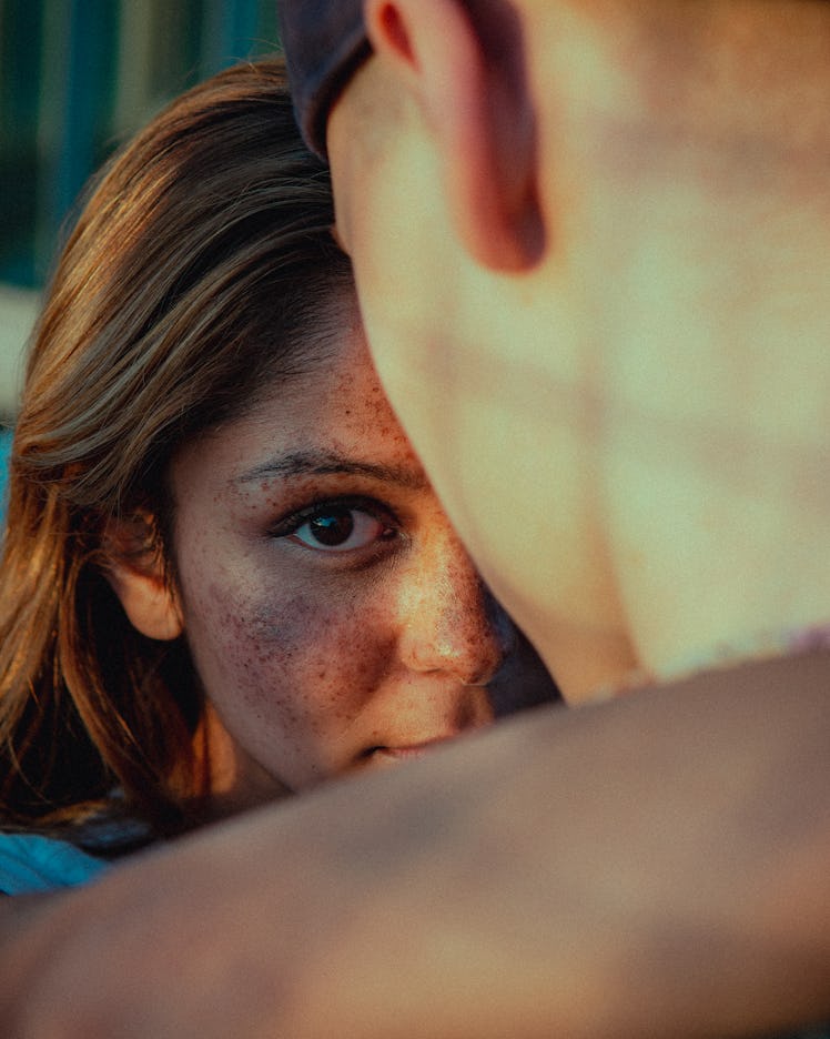 Young girl looking at the camera while holding a young boy