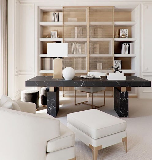 Chic home office with a sleek black marble desk placed in the center, and muted nude tones that domi...