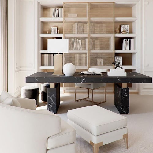 Chic home office with a sleek black marble desk placed in the center, and muted nude tones that domi...