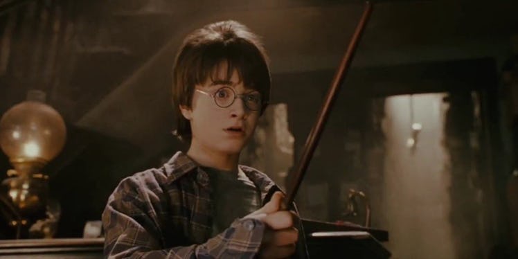 Daniel Radcliffe as Harry Potter with his wand in Harry Potter and the Chamber of Secrets