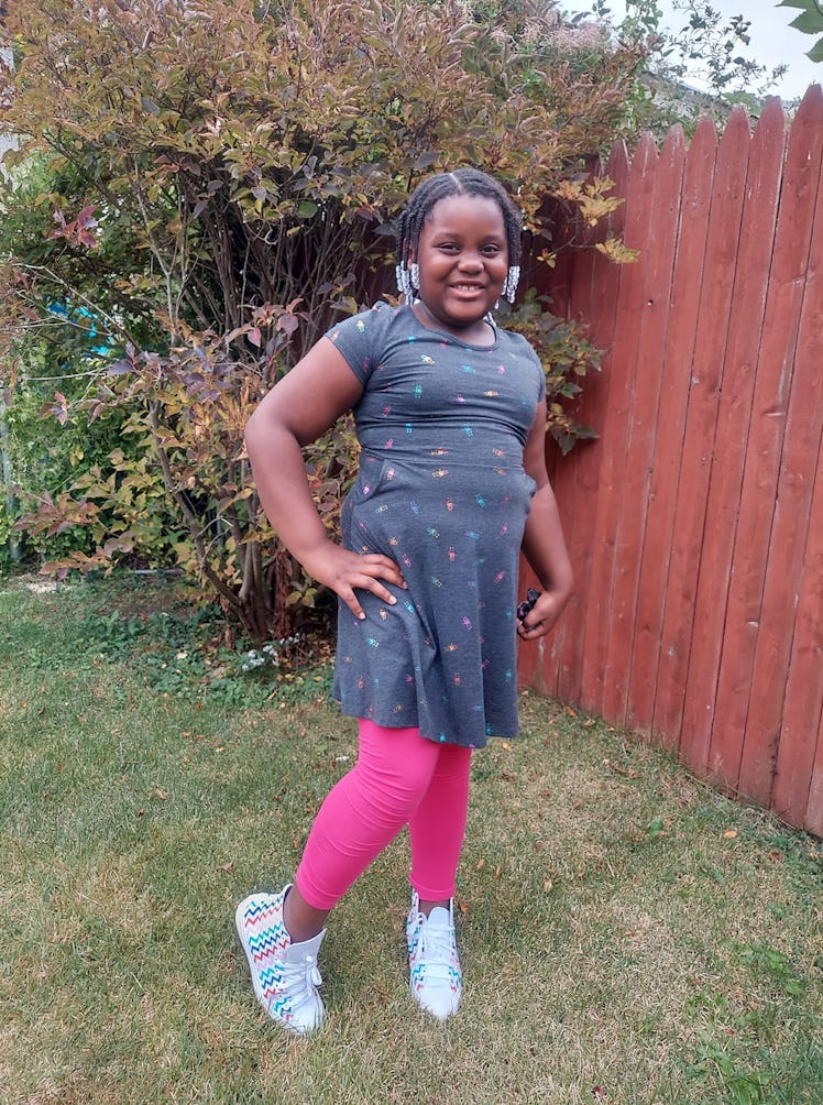 The author a 7-year-old Black girl, in ping leggings and her Converse sneakers.