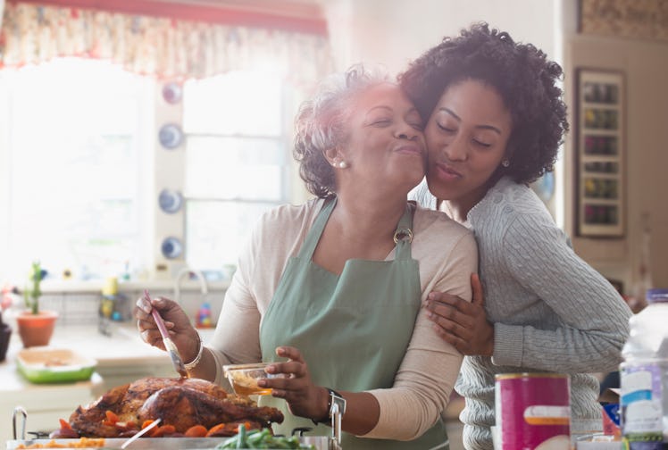 Mother and daughter cooking Thanksgiving together in kitchen