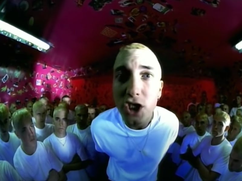 Closeup of rapper Eminem in video for "The Real Slim Shady" with lookalikes surrounding him in the b...