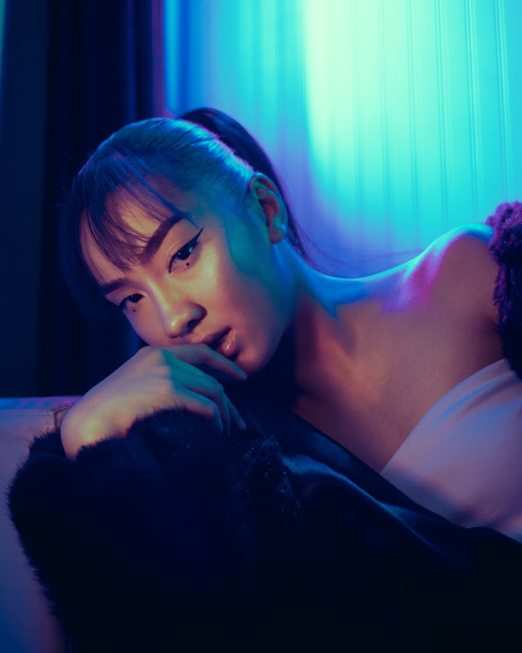 Young woman looking into the camera in neon room