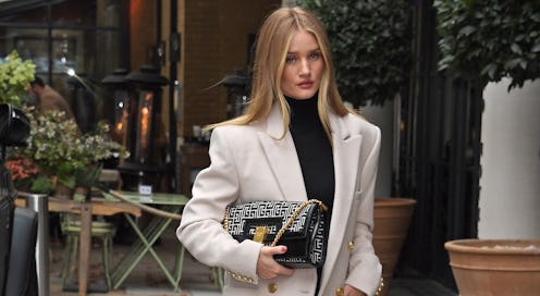 Rosie Huntington-Whiteley  in a white blazer and black turtleneck 