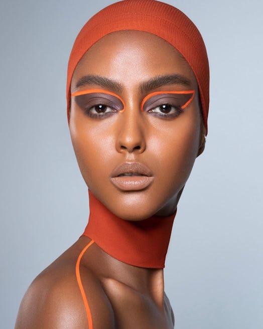 A model with makeup applied by Danessa Myricks with strong orange highlights