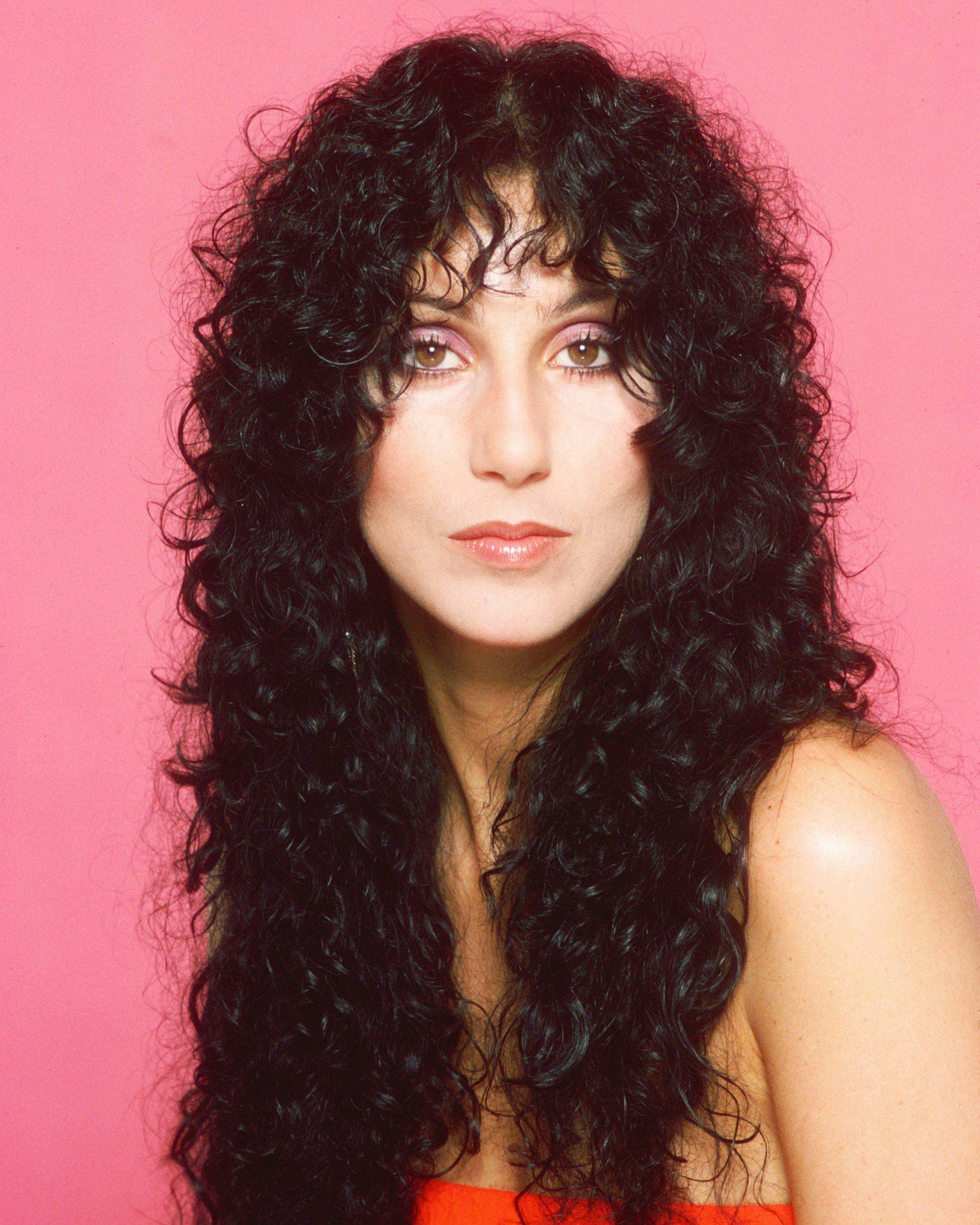 Cher with long curly hair.