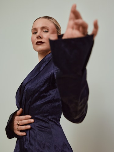 Kristen Bell in a dark blue Altuzarra jacket and skirt with a slit on the side