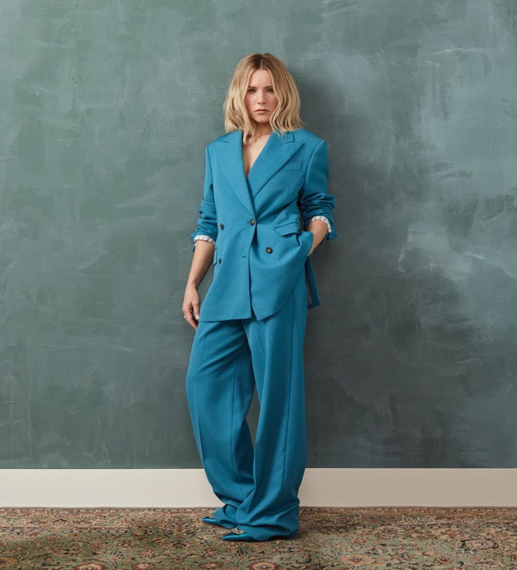 Kristen Bell in an oversized blue St. John jacket and pants and blue Manolo Blahnik shoes.