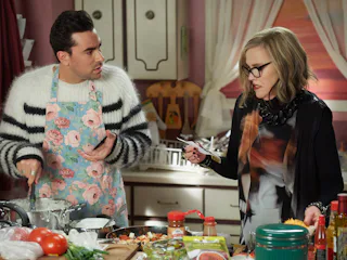 David (Dan Levy) tries to make enchiladas, while his mother, Moira (Catherine O'Hara), goes over the...