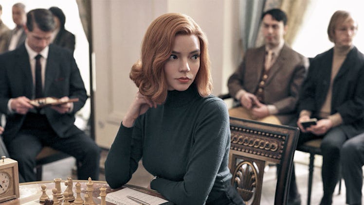 Beth (Anya Taylor-Joy) sits at a table with a chess game before her in 'The Queen's Gambit.'