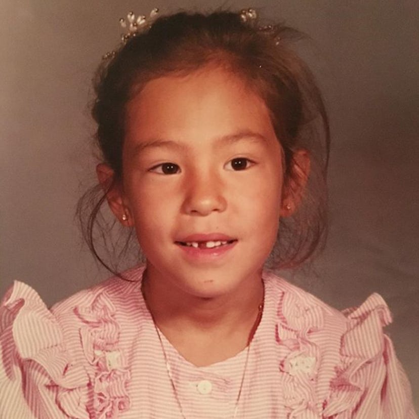 A photo of Joanna Gaines as a little girl, in which she wears a ruffly pink dress.