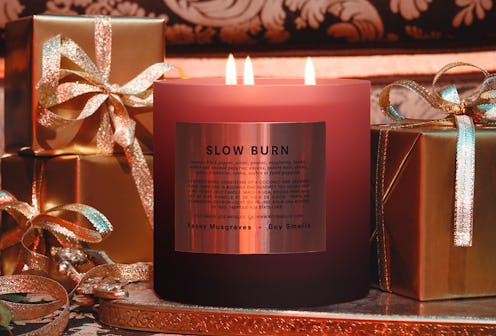 Boy Smells' Slow Burn Magnum Candle next to holiday presents.