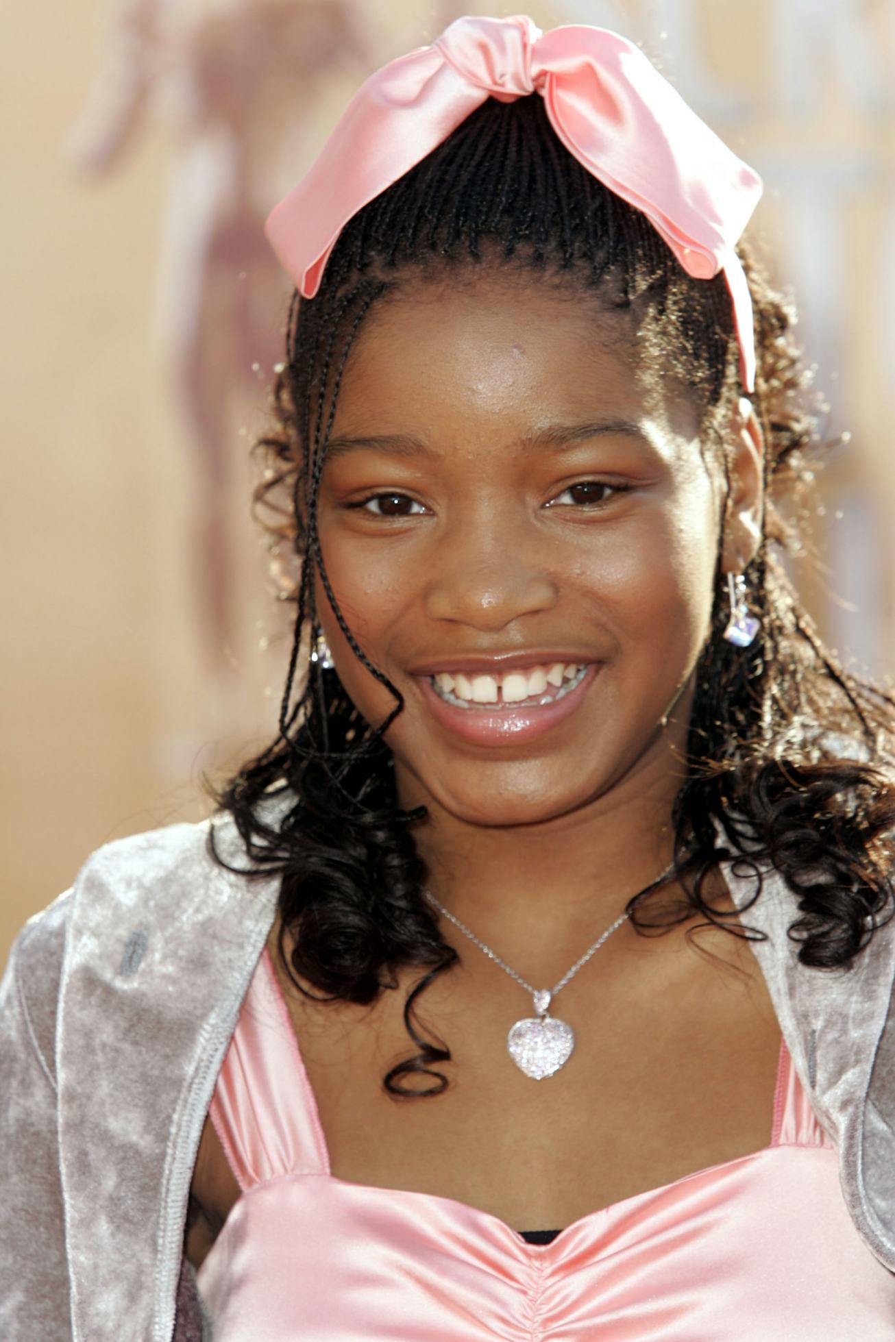 A young Keke Palmer wears a pink bow