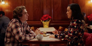 Dash and Lily from Netflix's 'Dash & Lily' sit across the table from each other in a NYC diner.