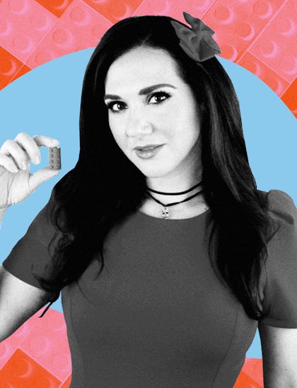 A black and white image of Jessica Ewud holding up a single LEGO brick on a blue background with a p...
