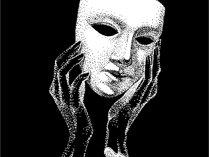 Hand holding a mask.