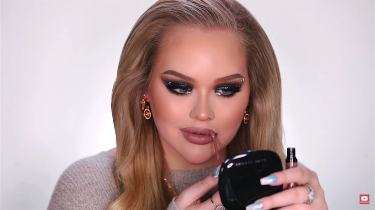 NikkieTutorials applying lipstick to her New Years' Eve makeup look.